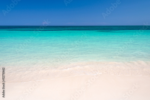 Sand and caribbean sea background © Delphotostock