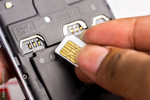 Hand put sim card to the sim card tray