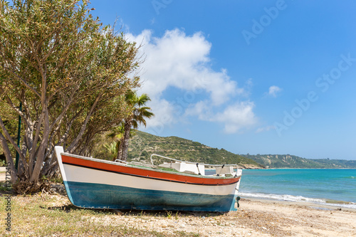 Colorful boat lying on greek beach