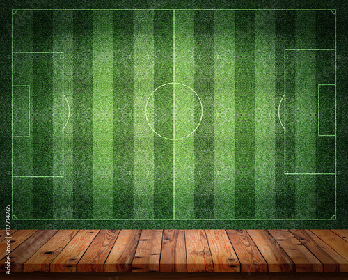 Konstfotografi Empty wooden table or counter with football field wall backgroun