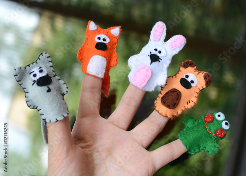 Hand wearing 5 finger puppets; wolf, fox, rabbit, bear, frog