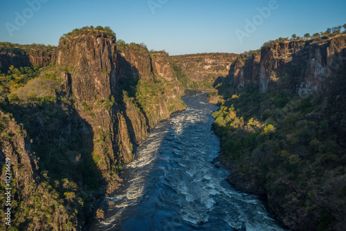 Aerial view of sunlit rapids from helicopter