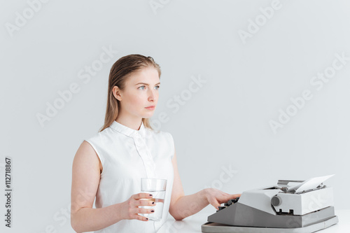 Woman worrking on retro print machine photo