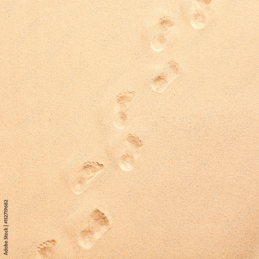 Line of footprints walking through beach sand Line of footprints walking through beach sand