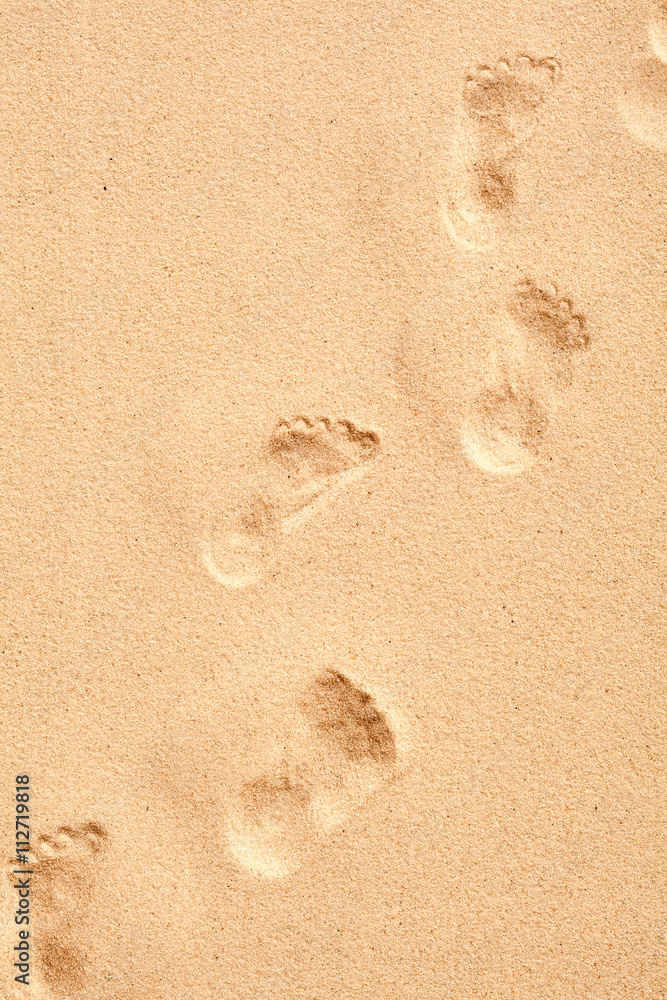Human footprints walking across the sand Human footprints walking across the sand