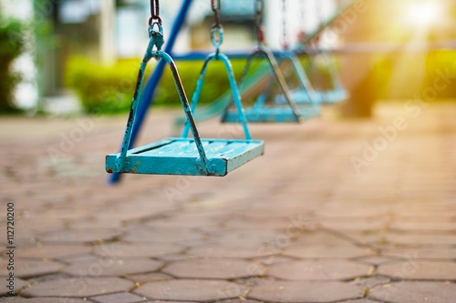 Closeup of swings in the park of morning