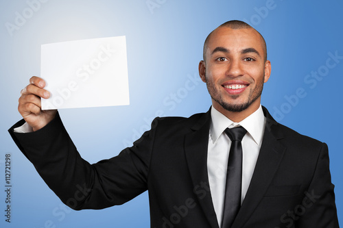 Portrait of a businessman showing a blank business card