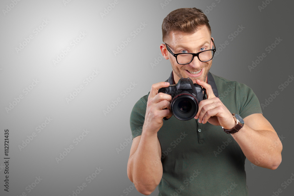 Portrait of a handsome young in glasses man with camera Portrait of a handsome young in glasses man with camera