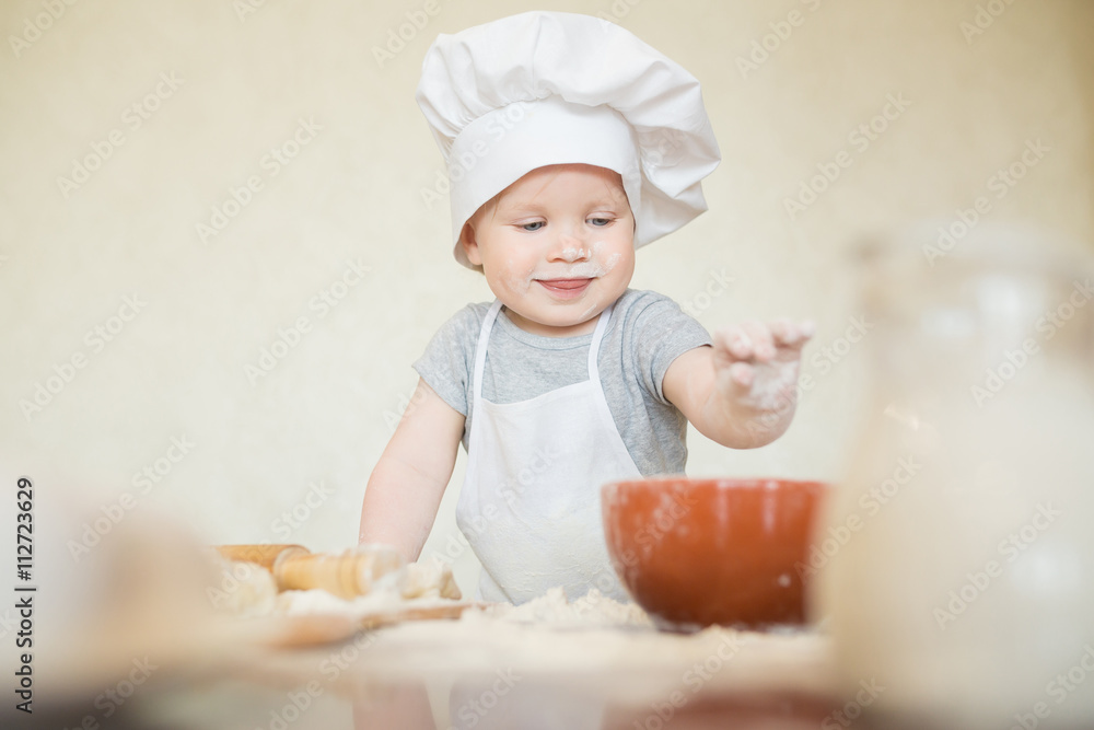 The little boy in a suit of the cook The little boy in a suit of the cook