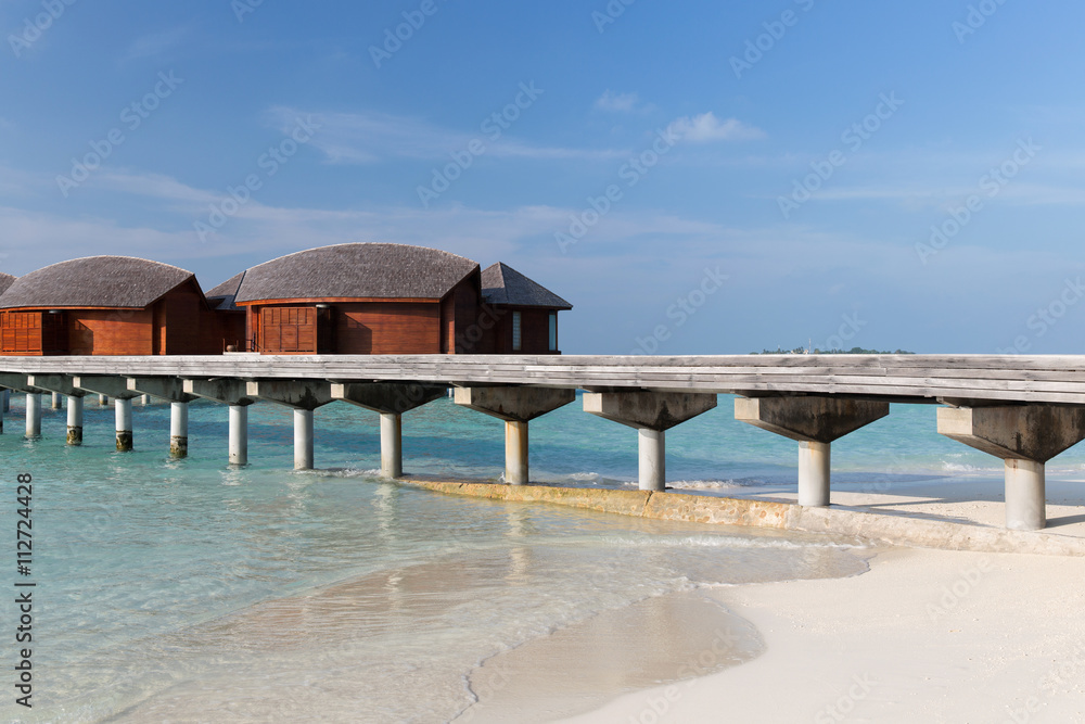 bungalow huts in sea water on exotic resort beach bungalow huts in sea water on exotic resort beach
