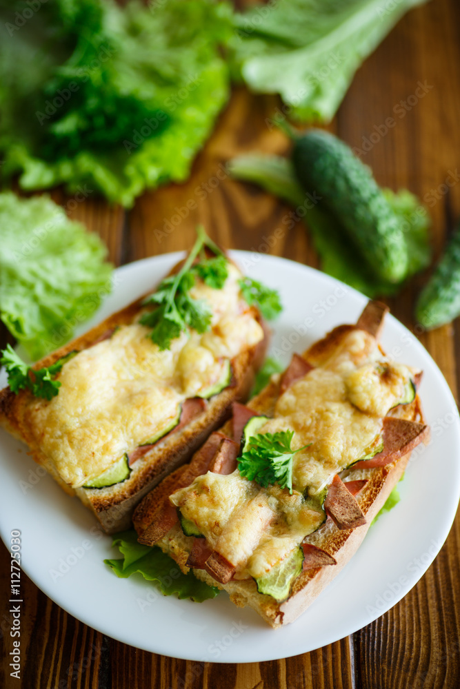 toast baked with sausage, cheese and cucumber