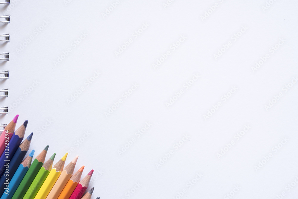 Fototapeta premium Color pencils and white paper note