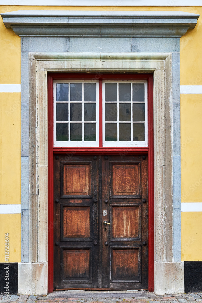Fototapeta premium Old decayed, dried out, double door of raw oak wood, in one of the storehouses around Kronborg Castle in Elsinore, Denmark