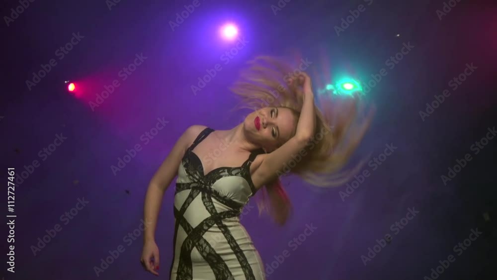 Blond girl dancing movement of head. Close-up. Slow motion Blond girl dancing movement of head. Close-up. Slow motion