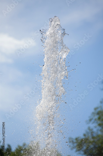 fountain splash water on a background of blue sky 