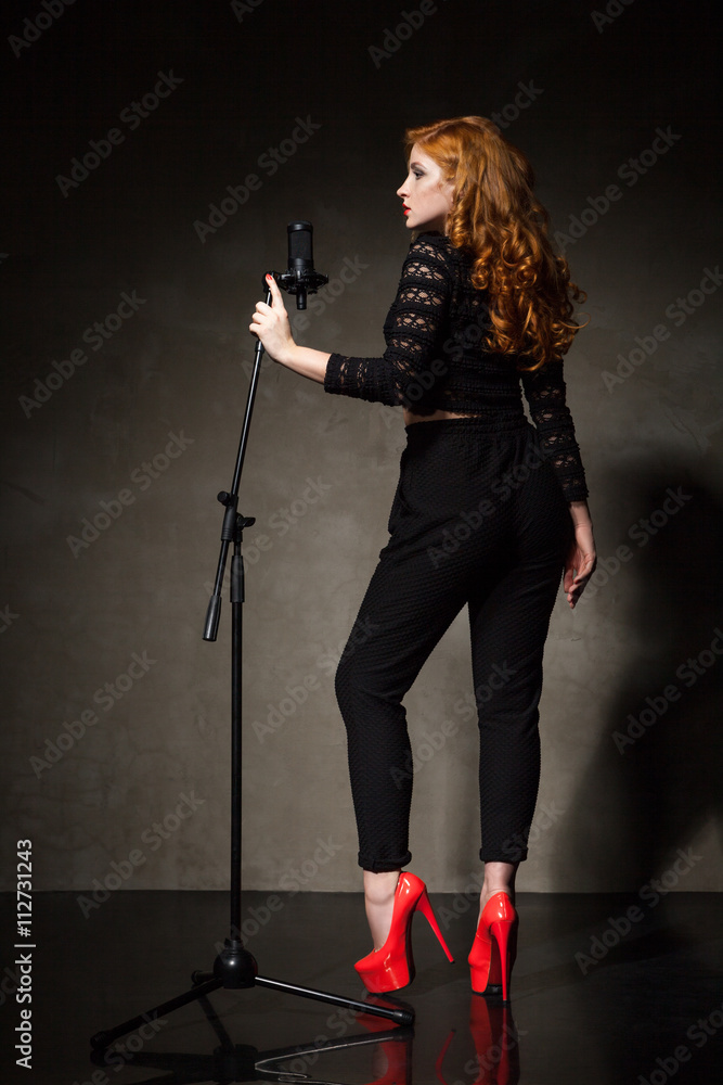 Diva in black and red heels signing song Diva in black and red heels signing song