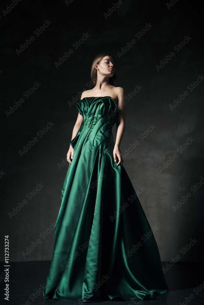 Model posing in green fashion dress
