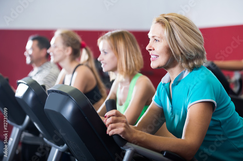 adults in gym working out at group class