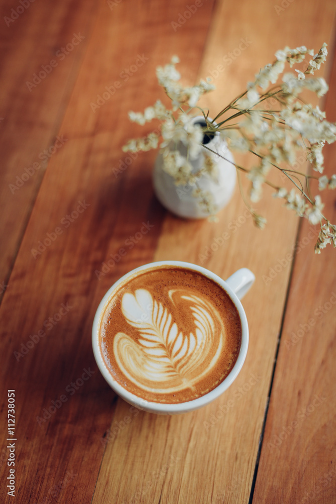 cup of coffee latte art on the wooden desk cup of coffee latte art on the wooden desk