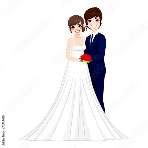 Beautiful young Asian couple hugging tenderly together posing on their wedding day