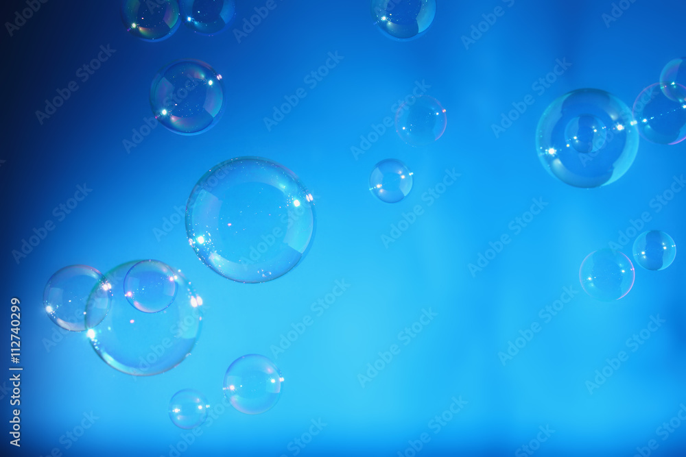 Rainbow soap bubbles on a blue backgrounds