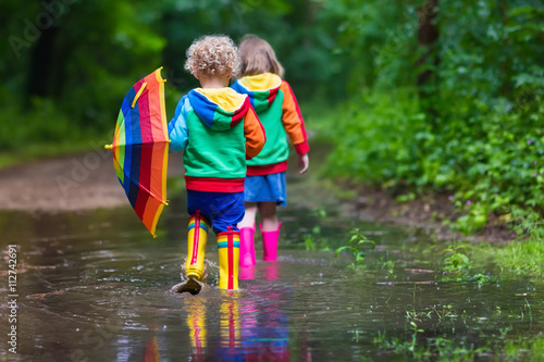 Fototapeta Naklejka Na Ścianę i Meble -  Kids playing in the rain