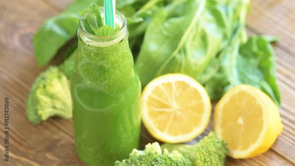 Fresh green smoothie on the wooden table Fresh green smoothie on the wooden table
