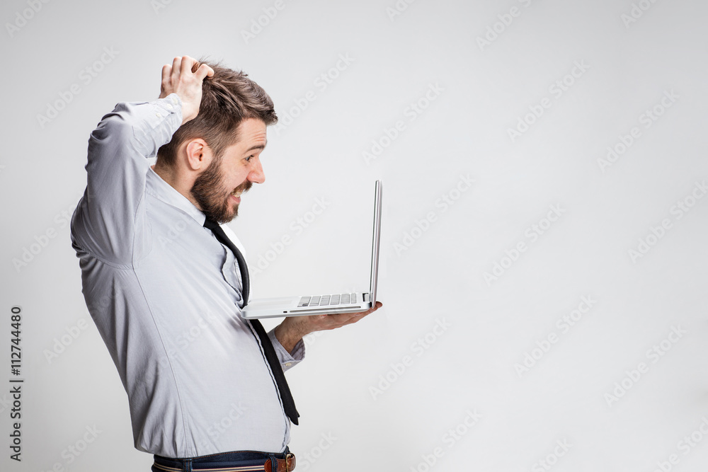 The young surprised man with his laptop computer The young surprised man with his laptop computer