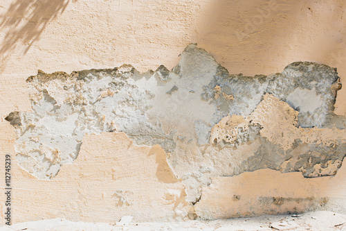 Crumbled plaster on exterior wall