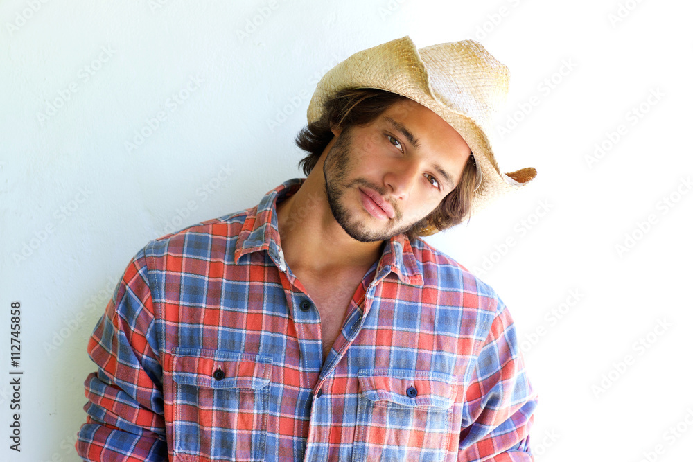 Rugged young man with plaid shirt and cowboy hat Rugged young man with plaid shirt and cowboy hat