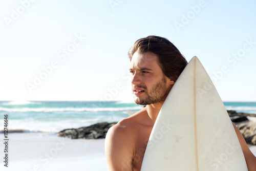 Portrait of young surfer at the beach