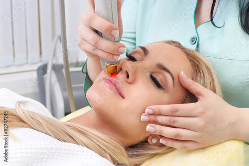 Woman having facial hair removal laser.