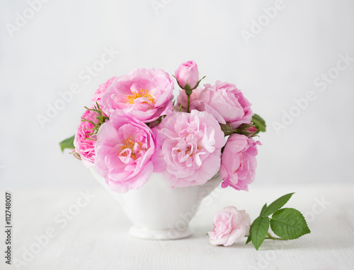 Pink flowers (rose) on light grey  background.