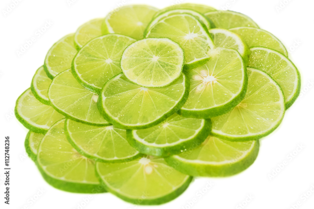 Abstract green background with citrus-fruit of lime slices. Close-up. Studio photography.