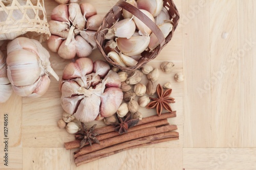Garlic has health benefits on wood background.