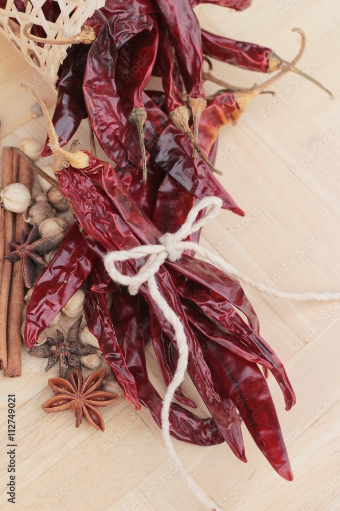 Dried chili for cooking on wood background.