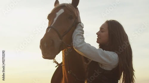 Young Girl Stroking and Hugging a Horse. Shot on RED Cinema Camera.
