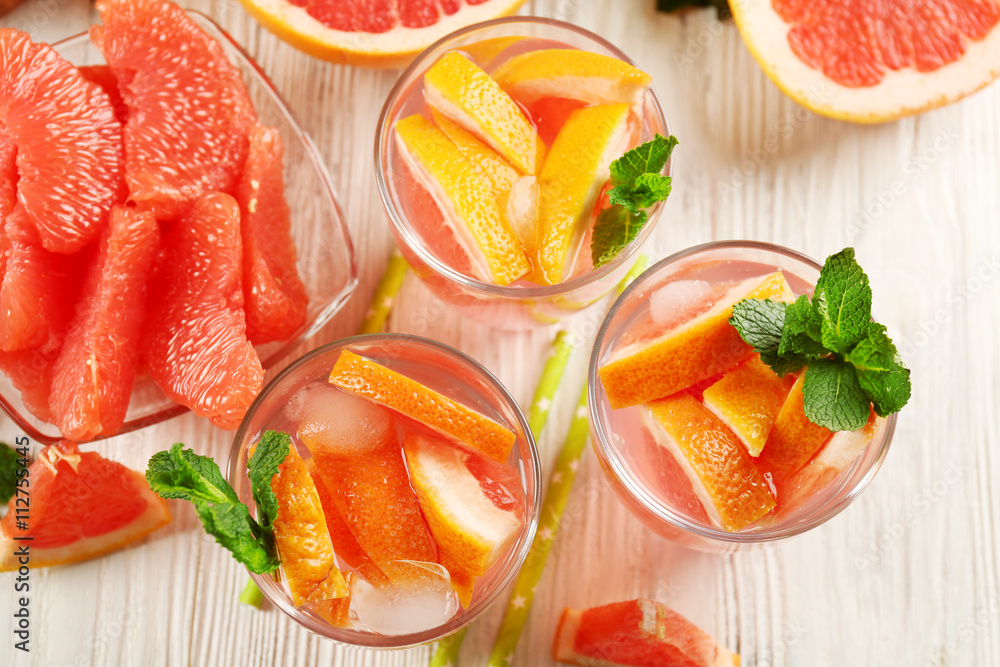 Ripe grapefruits and fresh juice with mint, close up