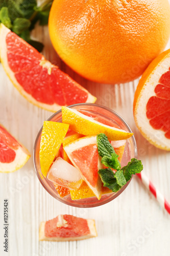 Ripe grapefruits and fresh juice with mint  close up