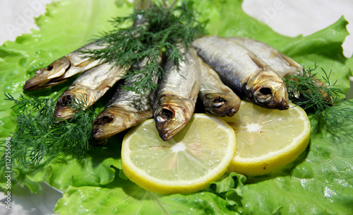 Smoked fish served with lemon photo