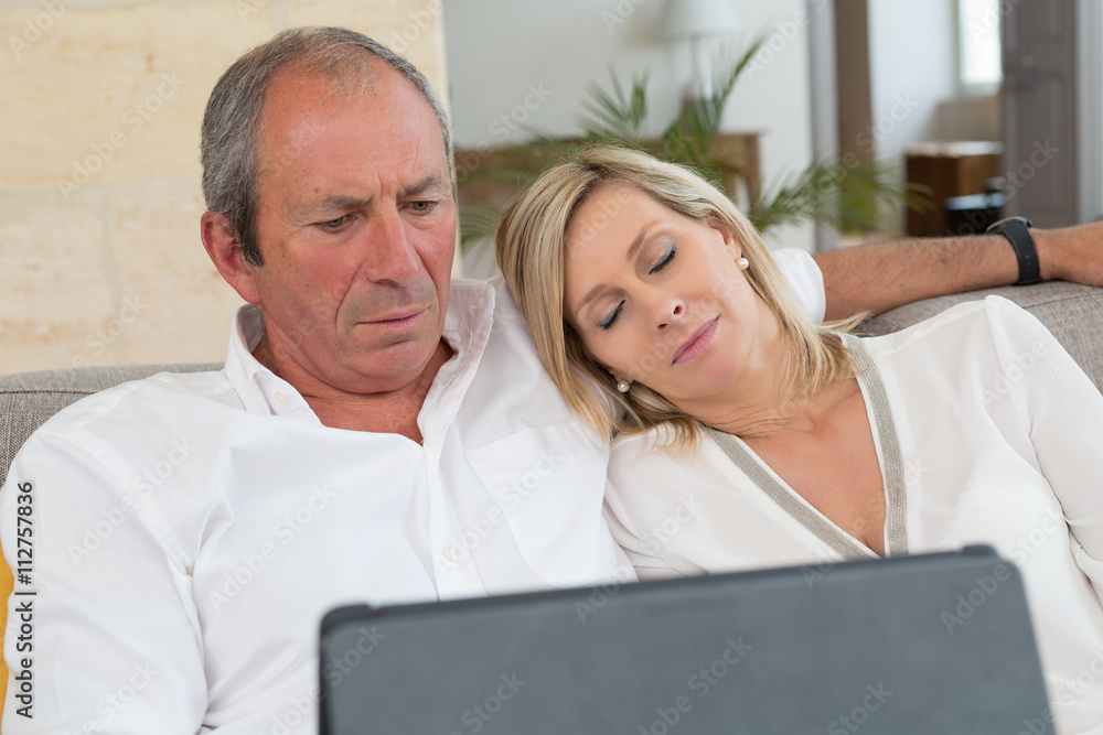 senior couple using electronics