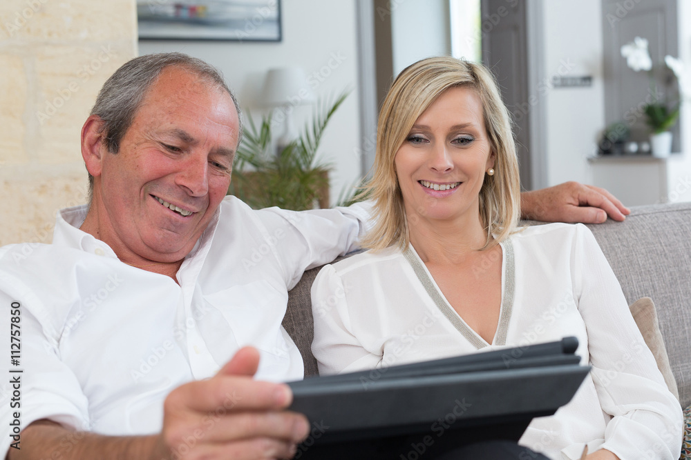 senior couple using electronics senior couple using electronics