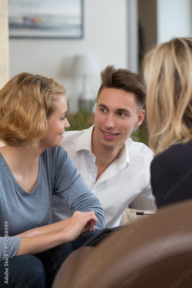 couple meeting real-estate to buy first home couple meeting real-estate to buy first home