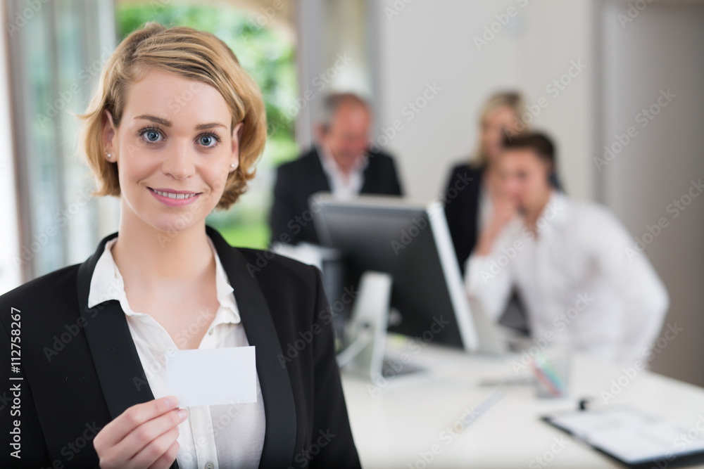 businesswoman holding blank visit card in office businesswoman holding blank visit card in office