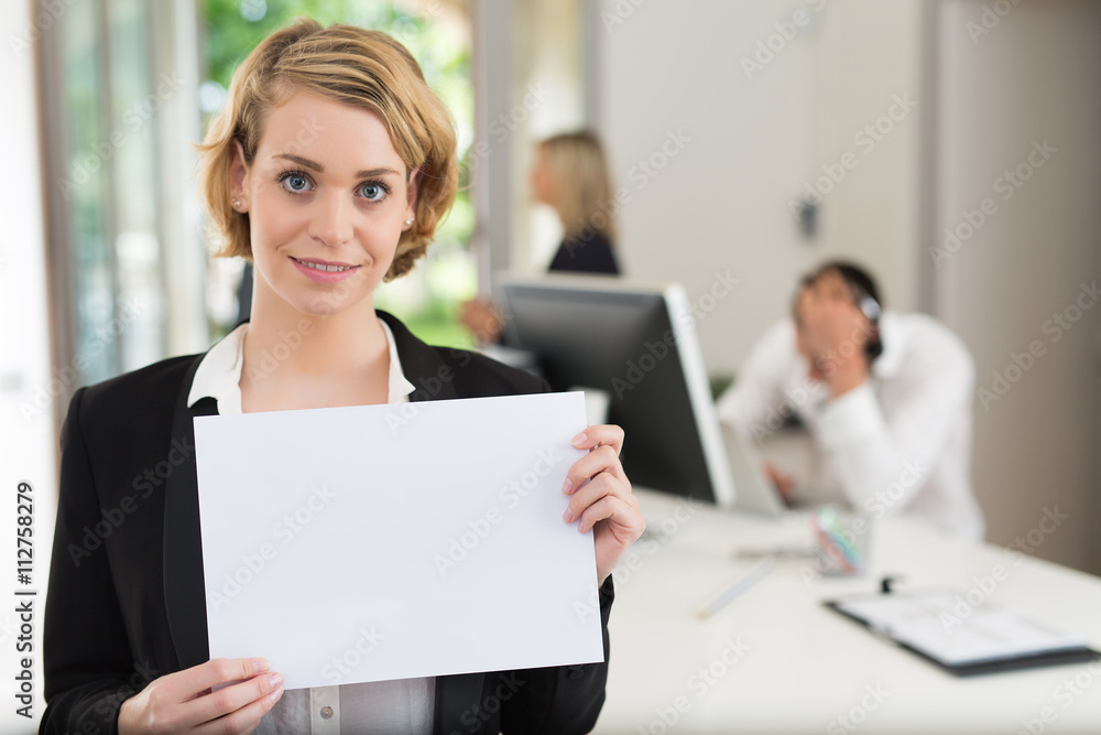 businesswoman holding blank sheet of paper in the office businesswoman holding blank sheet of paper in the office