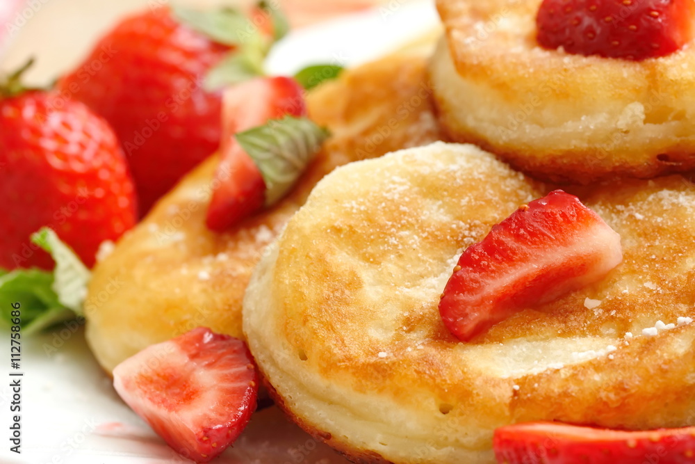 Pancakes with sugar powder and strawberry Pancakes with sugar powder and strawberry