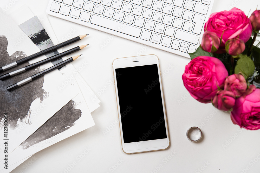 smartphone, computer keyboard and fesh pink flowers on white tab smartphone, computer keyboard and fesh pink flowers on white tab
