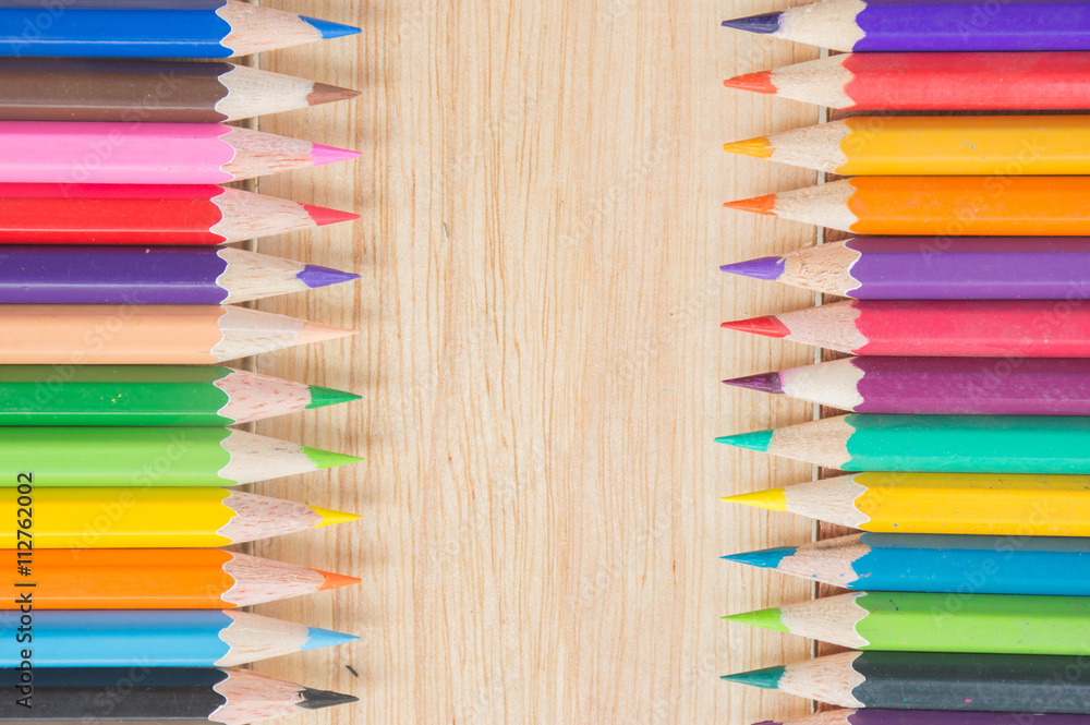 Colored pencils on a wooden background Colored pencils on a wooden background