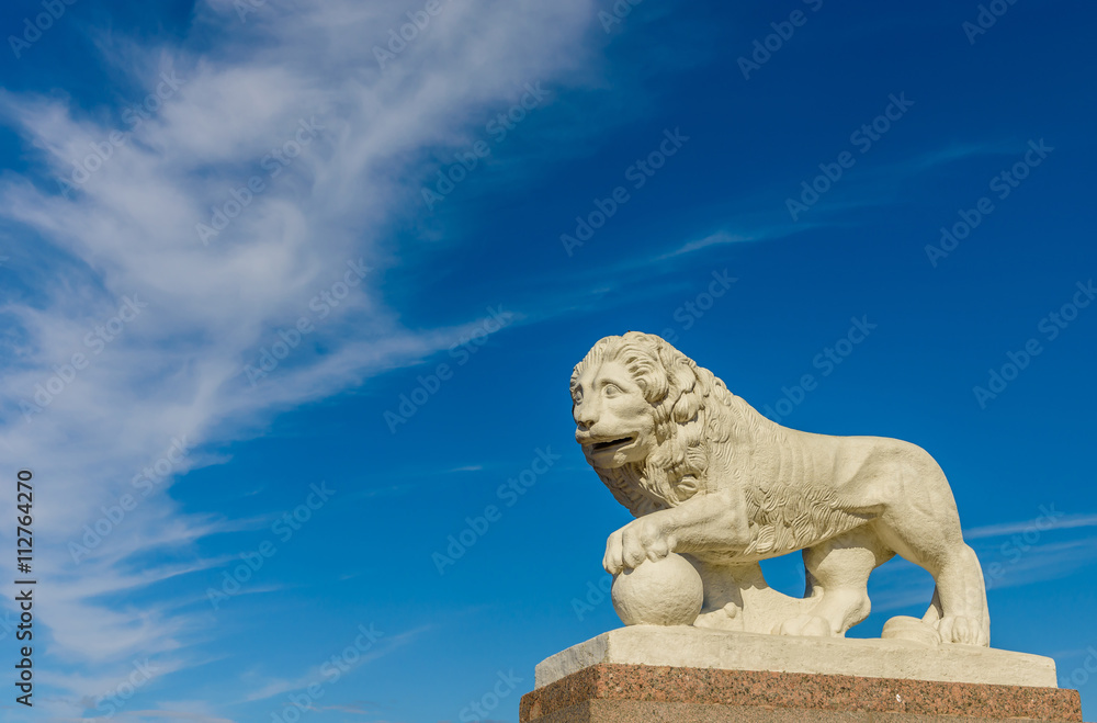 Sculpture of a lion on a background of blue sky,Saint-Petersburg , Russia.