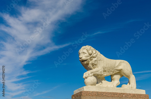 Sculpture of a lion on a background of blue sky,Saint-Petersburg , Russia.